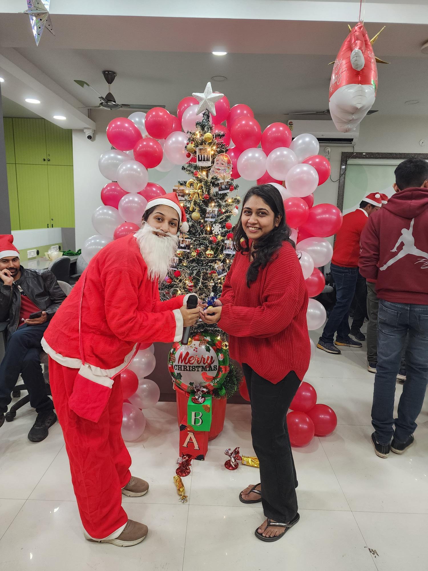 Santa distributing gifts at Genesis Christmas celebration